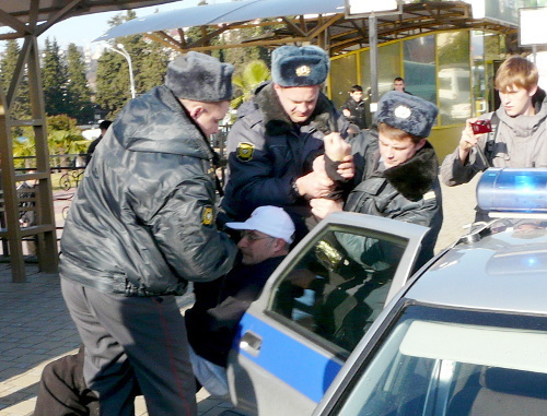 Policemen pushing rights defender Sergey Basmanov into a car a few minutes before the start of the protest action "Sochi for Honest Elections!", Sochi, Krasnodar Territory, December 10, 2011. Photo by Semyon Simonov for the "Caucasian Knot"