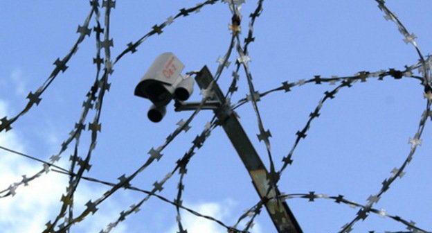 Barbed wire and surveillance camera over the prison wall. Courtesy of the press service of the UFSIN (Department of the Corrective Service) of Russia for Arkhangelsk Region