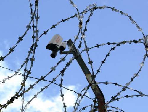 Barbed wire and surveillance camera over the prison wall. Courtesy of the press service of the UFSIN (Department of the Corrective Service) of Russia for Arkhangelsk Region