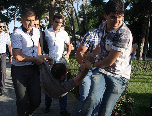 Azerbaijan, Baku, May 25, 2012: men in civilian clothes detain participants of promenade in Primorskiy Boulevard. Courtesy of the IA "Turan"