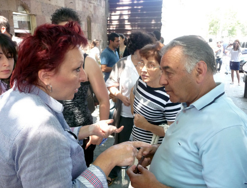 Residents of Yerevan discuss, during a protest action, dismantling of the indoor marketplace, Yerevan, May 28, 2012. Photo by Armine Martirosyan for the "Caucasian Knot"

 