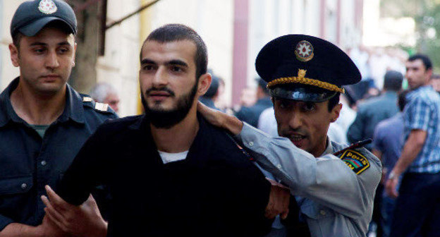 Policemen detaining believer-protester against the ban on wearing hijabs in schools; Azerbaijan, Baku, October 5, 2012. Photo by Aziz Karimov for the "Caucasian Knot"