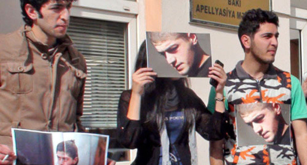 Group of young activists holding a silent protest action in front of the AppealCourt by sticking photos of Mamed Azizov to their clothes;Baku, February 27, 2013. Photo by Parvana Bairamova for the "Caucasian Knot"