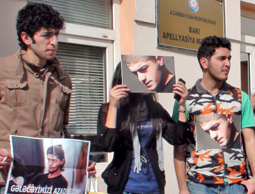 Group of young activists holding a silent protest action in front of the AppealCourt by sticking photos of Mamed Azizov to their clothes;Baku, February 27, 2013. Photo by Parvana Bairamova for the "Caucasian Knot"