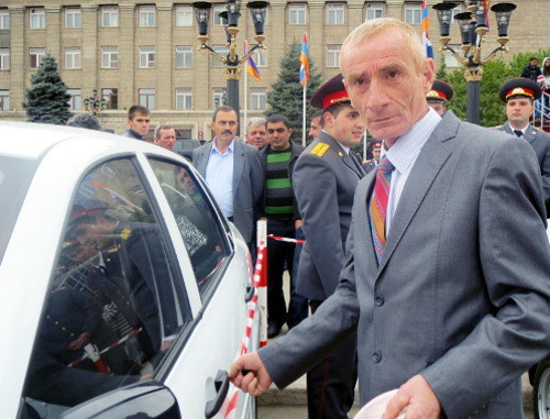 Karen Sarkisyan, a Karabakh War veteran, with a car, his gift on the occasion of triple holiday; Stepanakert, Nagorno-Karabakh, May 9, 2013. Photo by Alvard Grigoryan for the "Caucasian Knot"