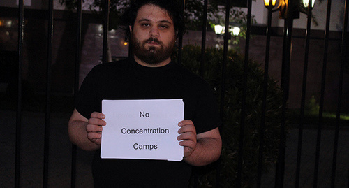 A participant of the action in support of homosexuals in Northern Caucasus with a poster "No Concentration Camps". Photo by Inna Kukudzhanova for "Caucasian Knot"