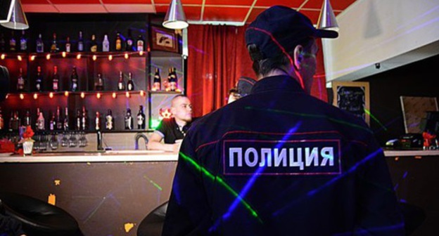 Policeman in a bar. Photo by Maria Mayer, IA 'Komiinform'