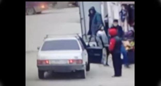 Teenager near the car. Screenshot from video posted by Nurmagomeg Astarkhanov,
https://www.youtube.com/watch?time_continue=34&v=A8kHYg7CJlU
