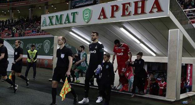 Football players enter the field at the "Akhmat Arena" Stadium on April 13, 2019. Photo by the press service of the "Lokomotiv" FC ttps://www.fclm.ru/ru/publications/news/19888