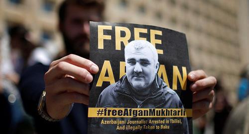 A poster with Afghan Mukhtarly's photo. Photo: REUTERS/David Mdzinarishvili