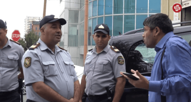 Journalist Tezekhan Miralamli argues with policemen, September 11, 2019. Screenshot from video: https://www.facebook.com/MeydanTelevision/videos/671447066668670/?v=671447066668670