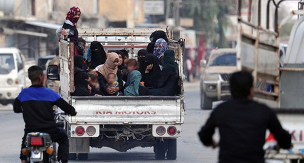 Women and children riding in a truck, October 2019. Photo: REUTERS/Khalil Ashawi