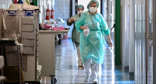 Health workers in protective clothing. Photo: REUTERS/Flavio Lo Scalzo