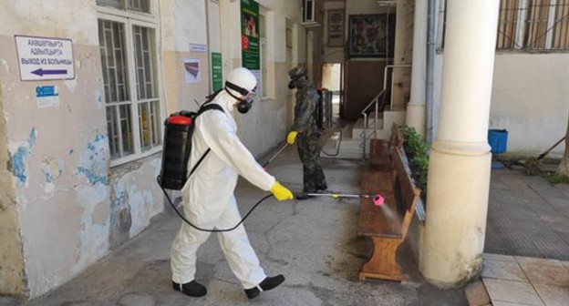 Worker in a protective suit is conducting disinfection, Abkhazia. Photo: press service of the Ministry for Emergencies of Abkhazia