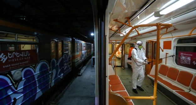 Worker conducts disinfection in Yerevan metro. Photo: Vahram Baghdasaryan/ REUTERS