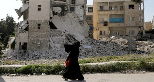 War in Syria. A woman with a child. Photo: REUTERS/Khalil Ashawi