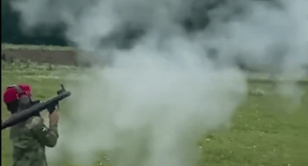 A child shooting from a grenade launcher. Screenshot of a video posted at the Lenta.ru website on 01.07.21, https://lenta.ru/news/2021/07/01/grntmt/