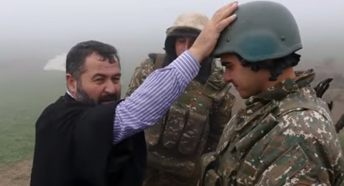 The priest blessed Armenian soldiers in the trenches. Screenshot of the video posted on YouTube ВООРУЖЕННЫЕ СИЛЫ MEDIA https://www.youtube.com/watch?v=FGXc0hWqj5M&amp;t=1s