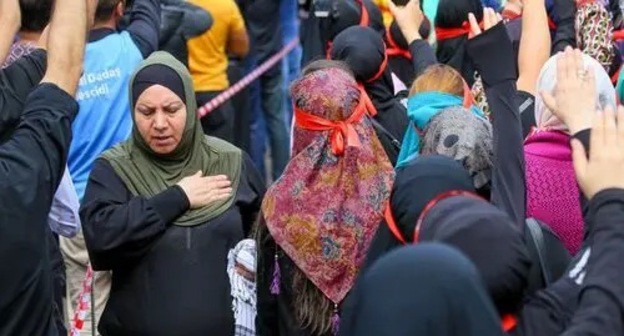 Believer hits herself in the chest with the palm of their hand as a sign of sorrow on the day of Ashura, September 2019. Photo by Aziz Karimov for the Caucasian Knot