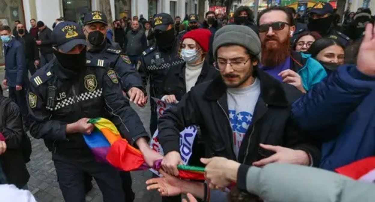 Policemen take away a rainbow flag from a participant of a rally in Baku, March 2022. Photo by Aziz Karimov for the Caucasian Knot