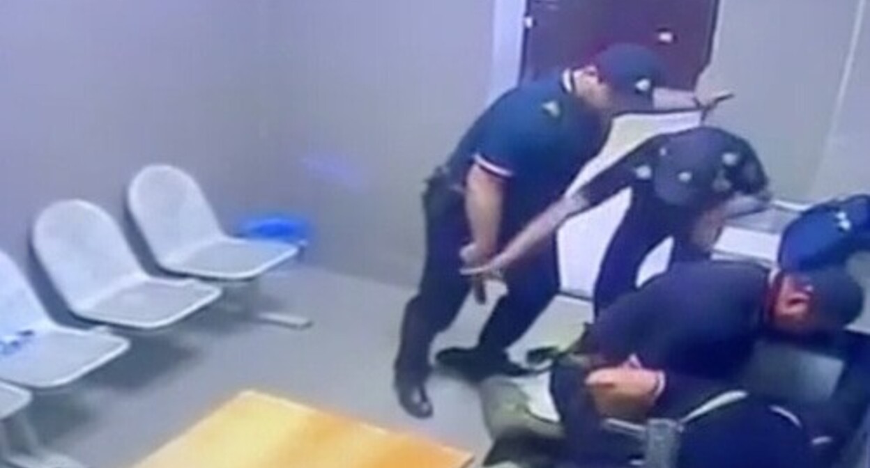 Law enforcers physically assault Akhmed Djabrailov, detained by police. Screenshot of a video by the Russian Ministry of Internal Affairs