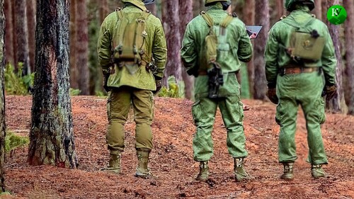 Militaries standing in a forest. Picture made in Photoshop by the "Caucasian Knot"